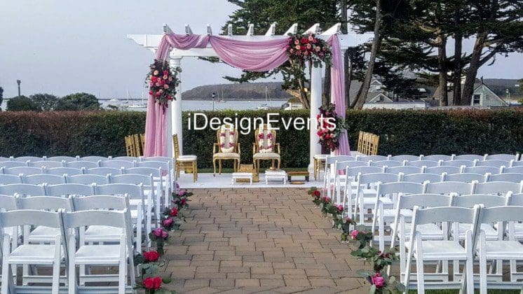 Futuristic roller coaster inside a vibrant, neon-lit indoor amusement park.
