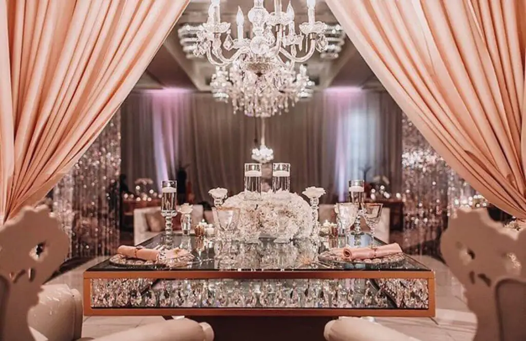 Futuristic roller coaster inside a vibrant, neon-lit indoor amusement park.