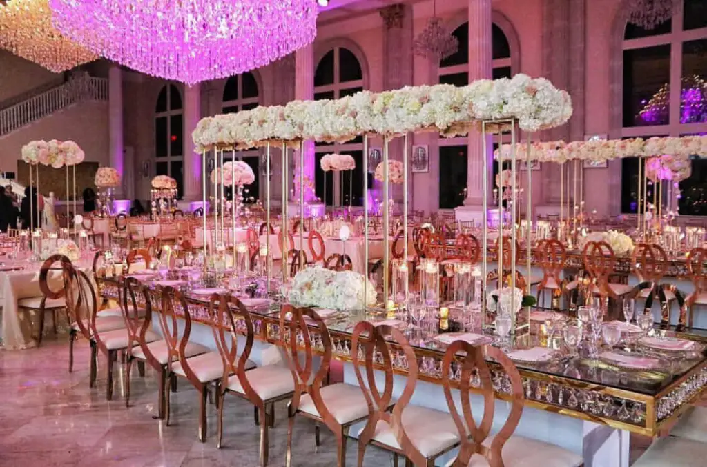 Futuristic roller coaster inside a vibrant, neon-lit indoor amusement park.