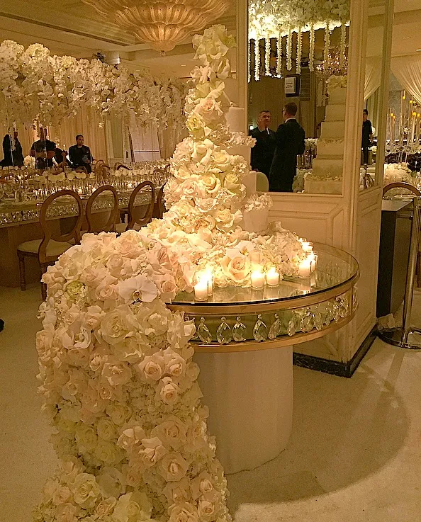 Futuristic roller coaster inside a vibrant, neon-lit indoor amusement park.
