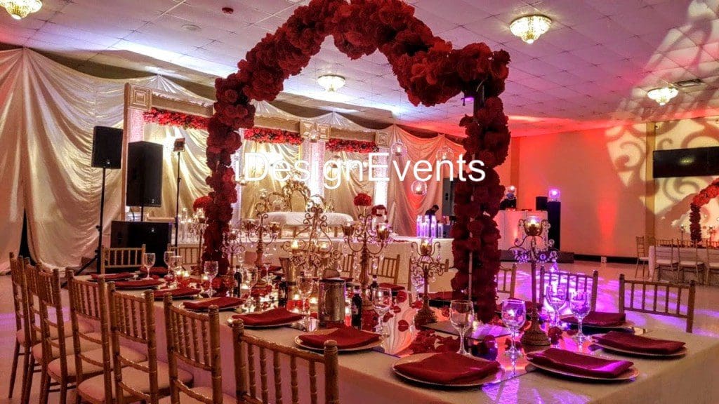 Futuristic roller coaster inside a vibrant, neon-lit indoor amusement park.