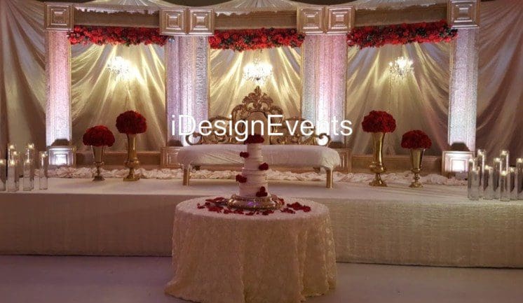 Futuristic roller coaster inside a vibrant, neon-lit indoor amusement park.