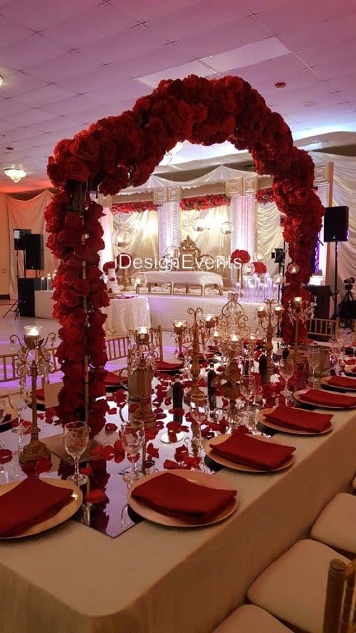 Futuristic roller coaster inside a vibrant, neon-lit indoor amusement park.
