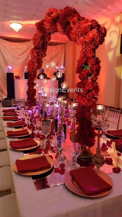 Futuristic roller coaster inside a vibrant, neon-lit indoor amusement park.