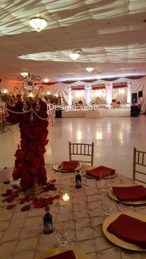 Futuristic roller coaster inside a vibrant, neon-lit indoor amusement park.