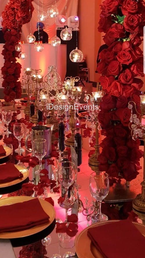 Futuristic roller coaster inside a vibrant, neon-lit indoor amusement park.