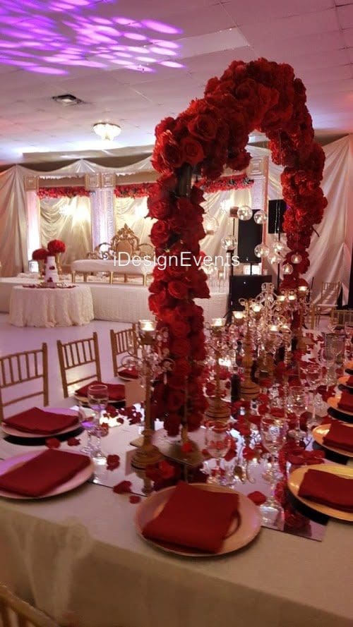 Futuristic roller coaster inside a vibrant, neon-lit indoor amusement park.