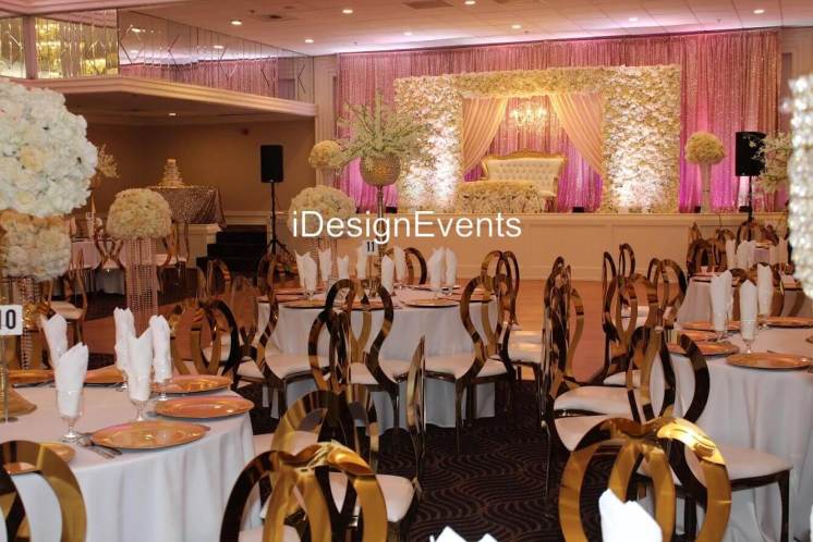 Futuristic roller coaster inside a vibrant, neon-lit indoor amusement park.