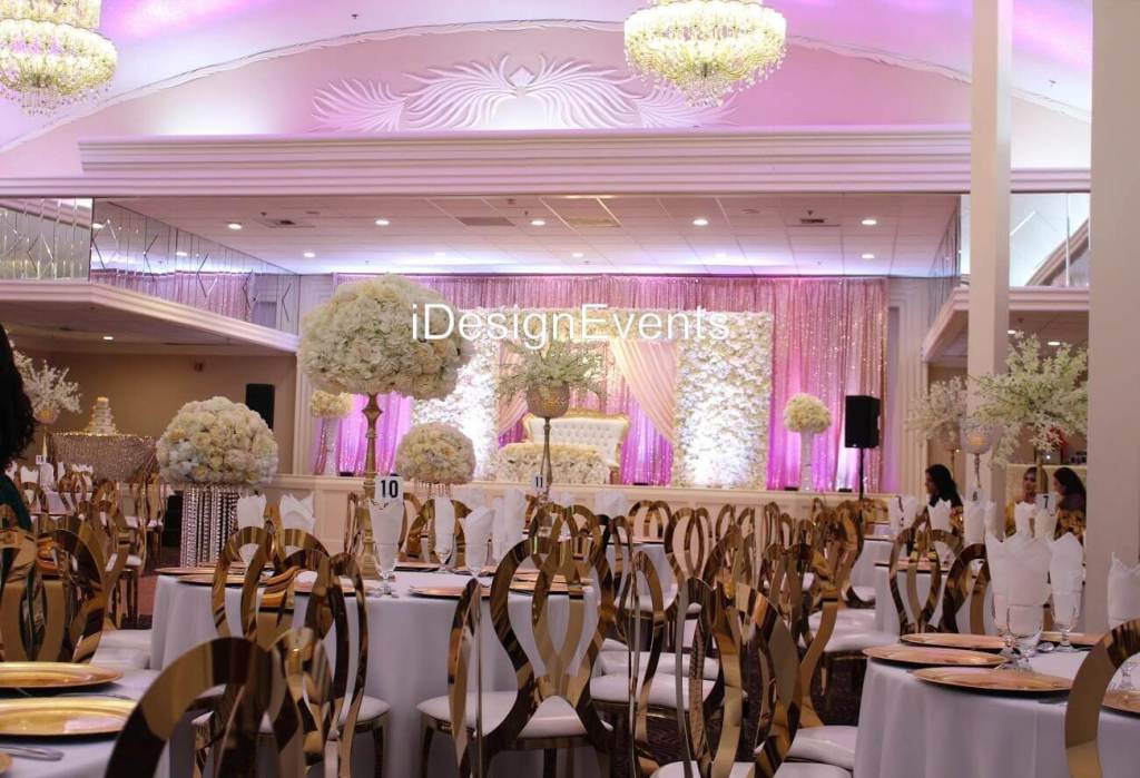 Futuristic roller coaster inside a vibrant, neon-lit indoor amusement park.