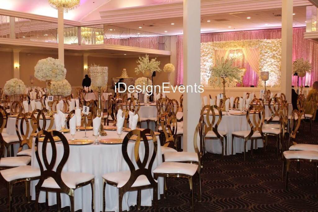 Futuristic roller coaster inside a vibrant, neon-lit indoor amusement park.