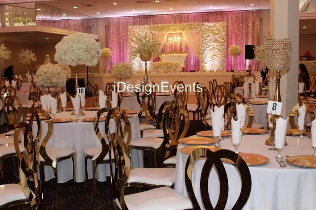Futuristic roller coaster inside a vibrant, neon-lit indoor amusement park.