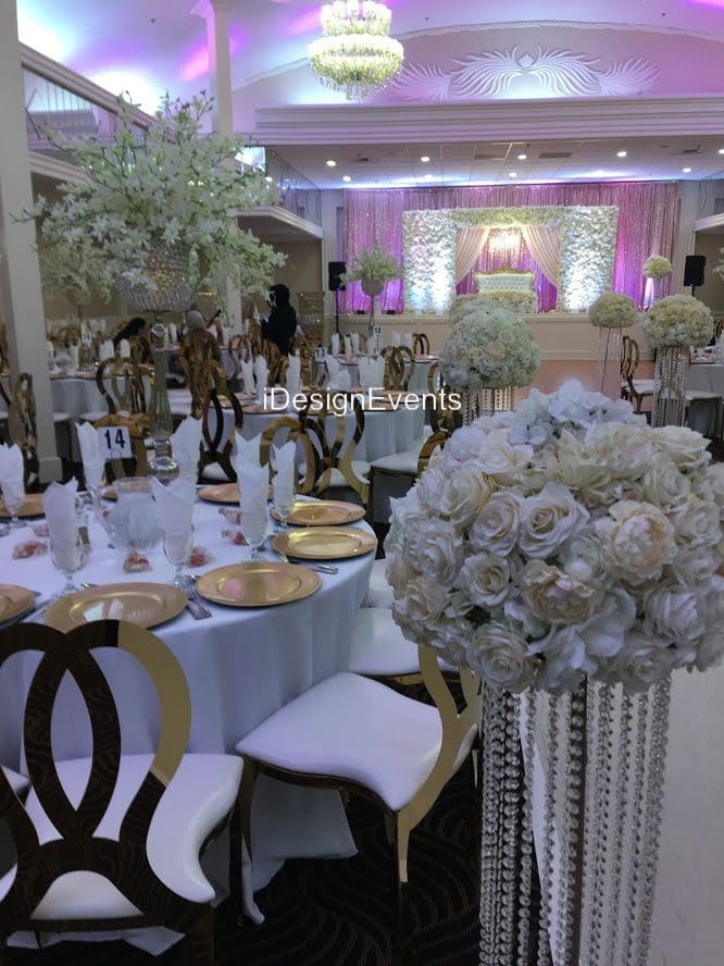 Futuristic roller coaster inside a vibrant, neon-lit indoor amusement park.