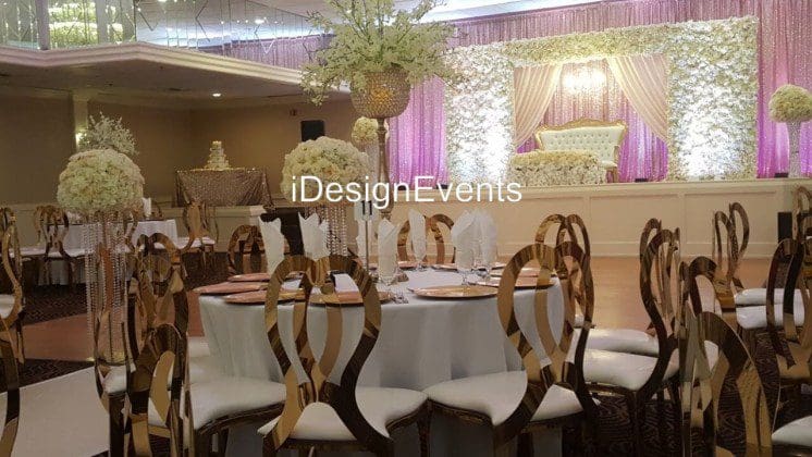 Futuristic roller coaster inside a vibrant, neon-lit indoor amusement park.