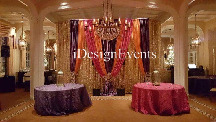 Futuristic roller coaster inside a vibrant, neon-lit indoor amusement park.