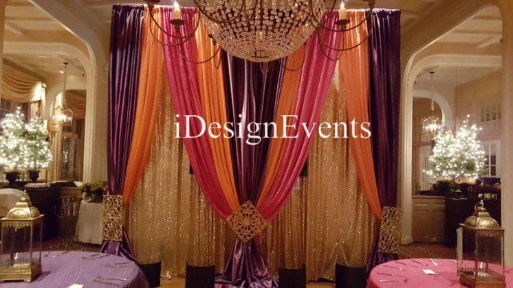 Futuristic roller coaster inside a vibrant, neon-lit indoor amusement park.