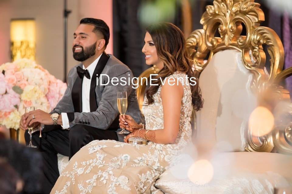 Futuristic roller coaster inside a vibrant, neon-lit indoor amusement park.