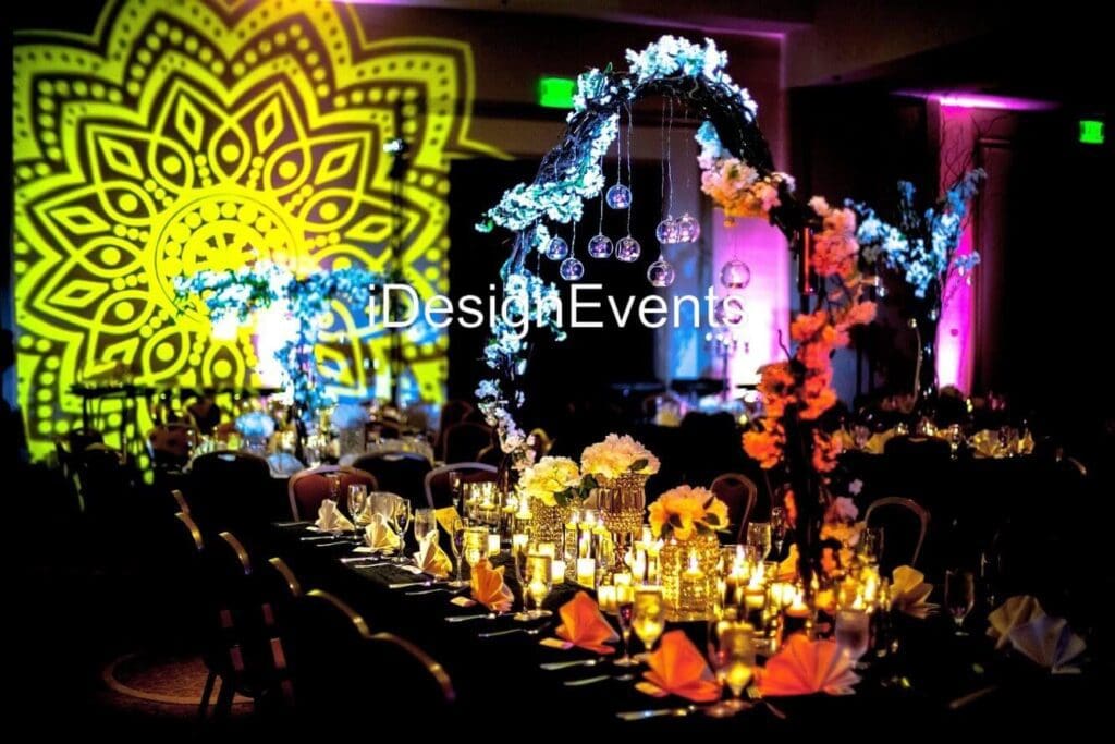 Futuristic roller coaster inside a vibrant, neon-lit indoor amusement park.
