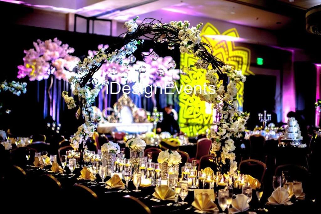 Futuristic roller coaster inside a vibrant, neon-lit indoor amusement park.