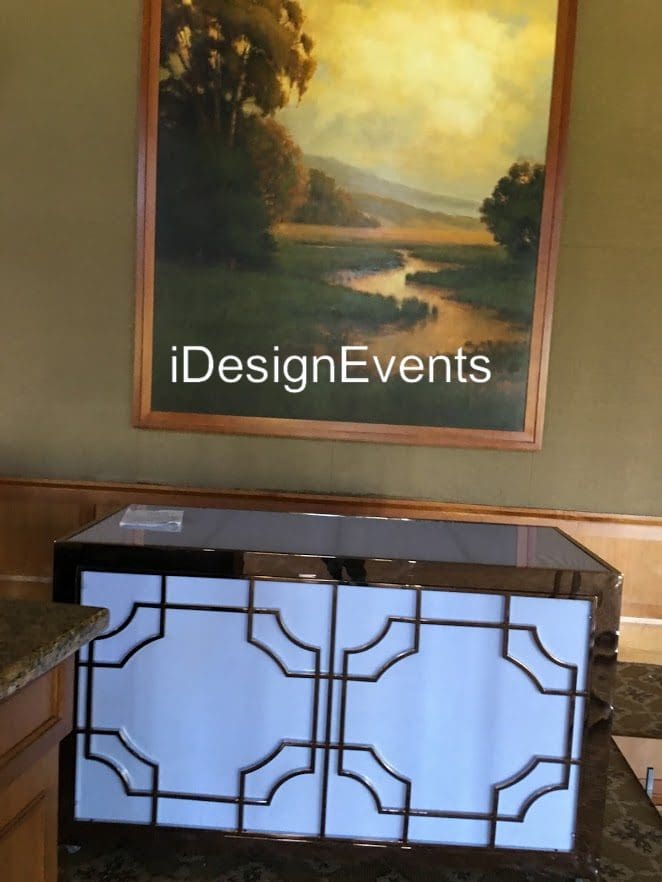 Futuristic roller coaster inside a vibrant, neon-lit indoor amusement park.