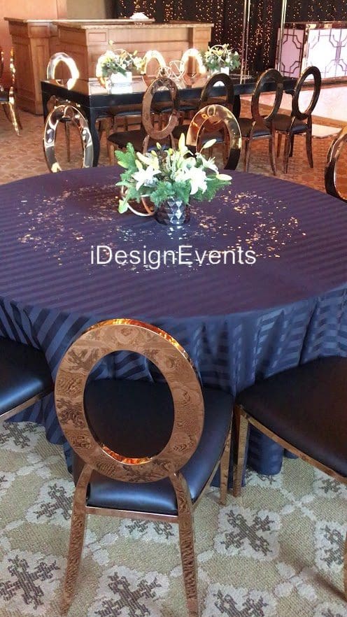 Futuristic roller coaster inside a vibrant, neon-lit indoor amusement park.