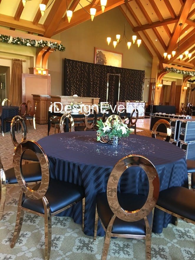 Futuristic roller coaster inside a vibrant, neon-lit indoor amusement park.
