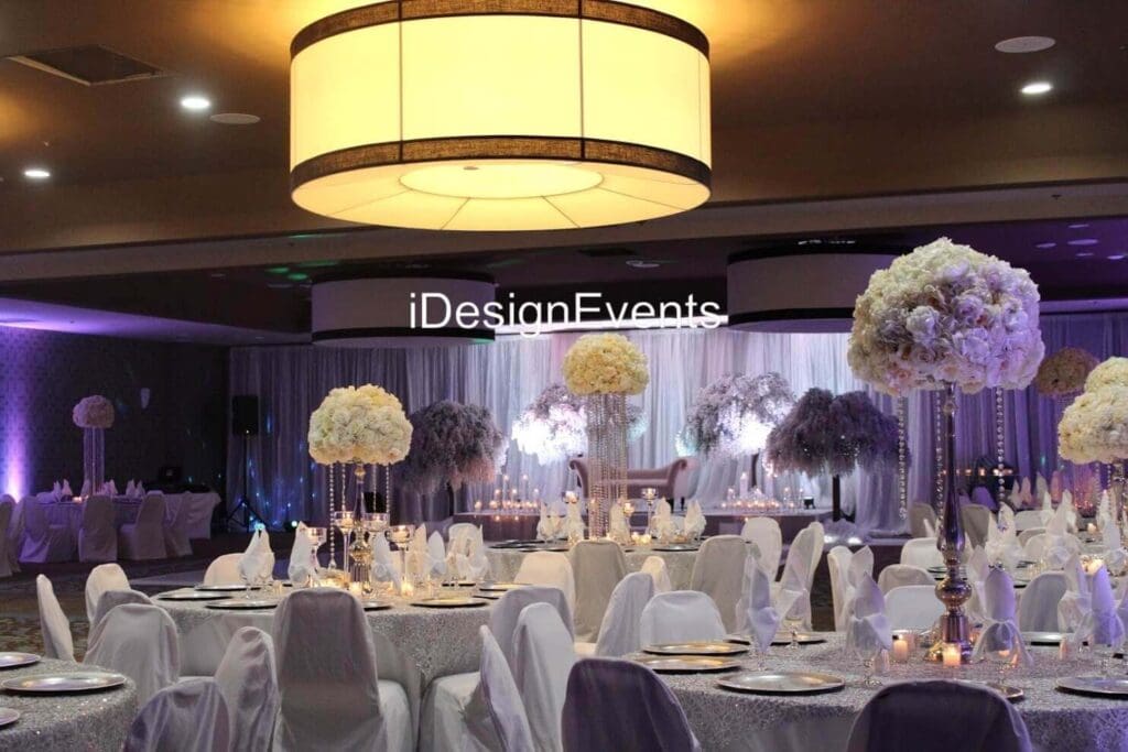 Futuristic roller coaster inside a vibrant, neon-lit indoor amusement park.