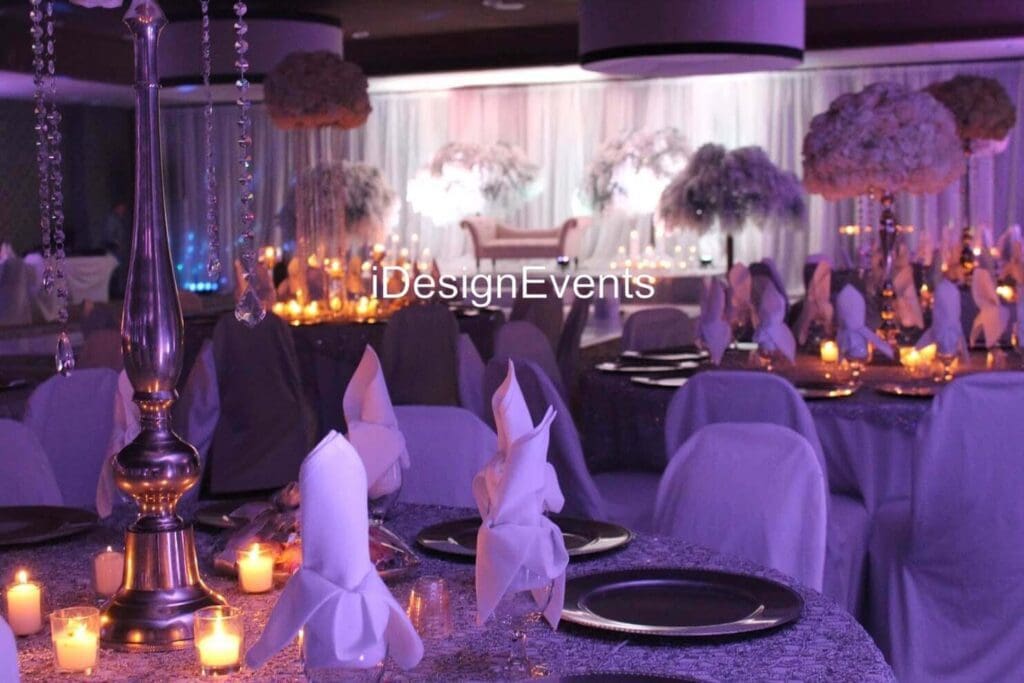 Futuristic roller coaster inside a vibrant, neon-lit indoor amusement park.