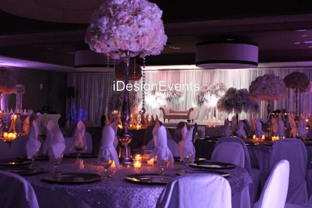 Futuristic roller coaster inside a vibrant, neon-lit indoor amusement park.