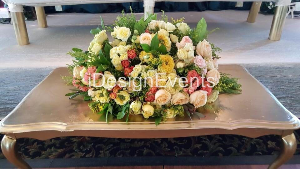 Elegant floral arrangement with roses and greenery on a table.