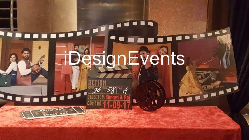 A film-themed event setup with a vintage camera and clapperboard.