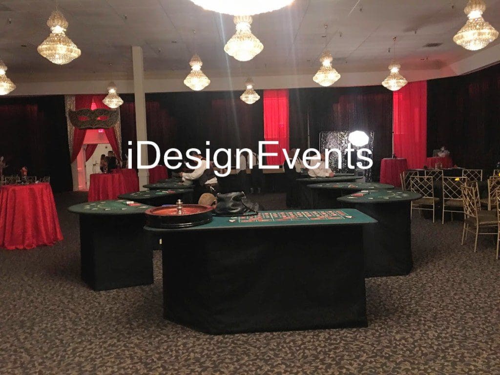 Elegant event setup with black and red decor and a central round table.