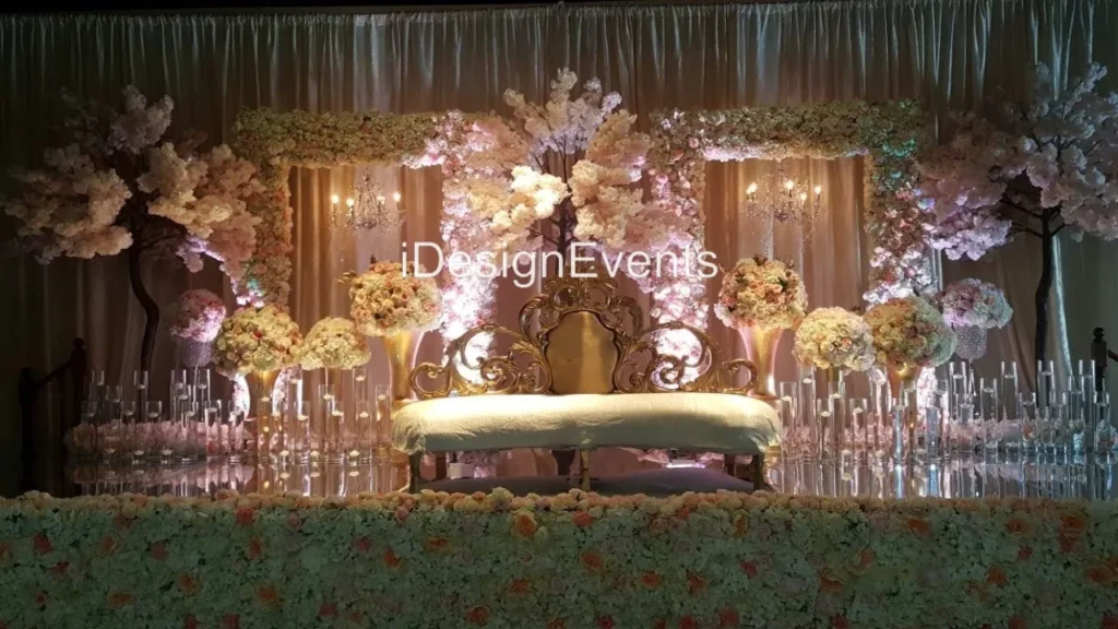 Elegant glass candle holders with lit candles reflecting on a glossy surface.