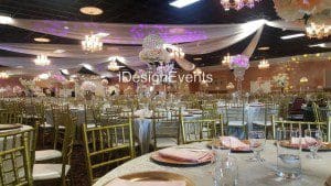 Elegant wedding reception setup with pink and white floral centerpieces.