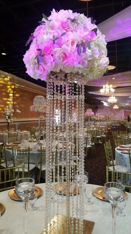 Elegant centerpiece with pink and white flowers and cascading crystal strands.