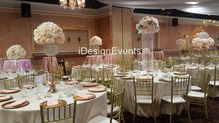 Elegant wedding reception with floral centerpieces and gold accents.