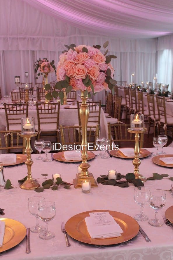 Elegant table setting with pink floral centerpiece and gold accents.