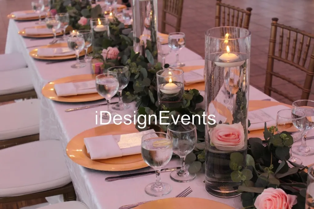 Elegant table setting with candles and floral centerpiece for an event.