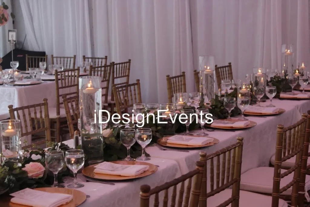 Elegant table setting with candles and floral centerpieces for an event.