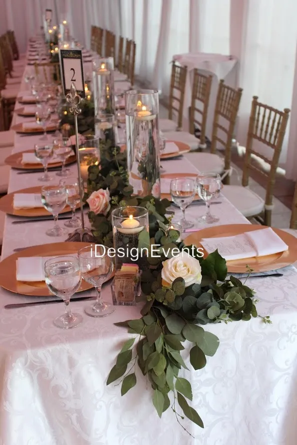Elegant wedding table setting with floral centerpiece and candles.