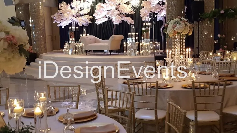 Elegant wedding reception setup with floral centerpieces and candlelight.