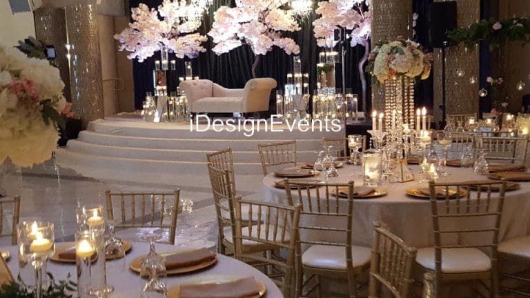 Elegant wedding reception setup with floral centerpieces and candlelight.