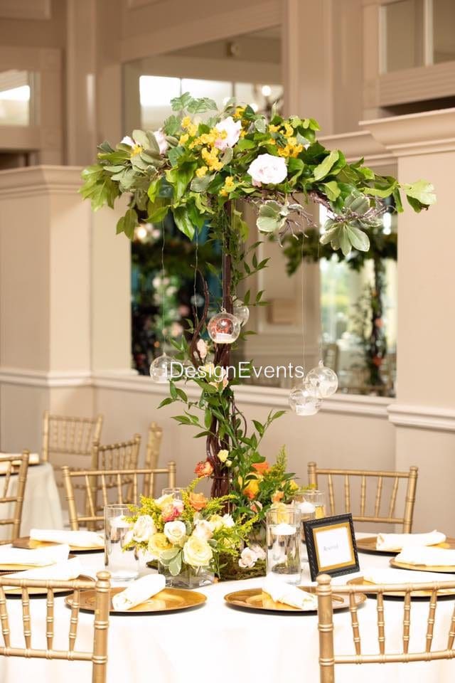 Elegant floral centerpiece with cascading greenery at a formal event.