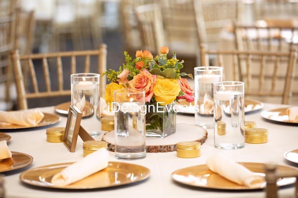 Elegant table setting with floral centerpiece and candles for a formal event.