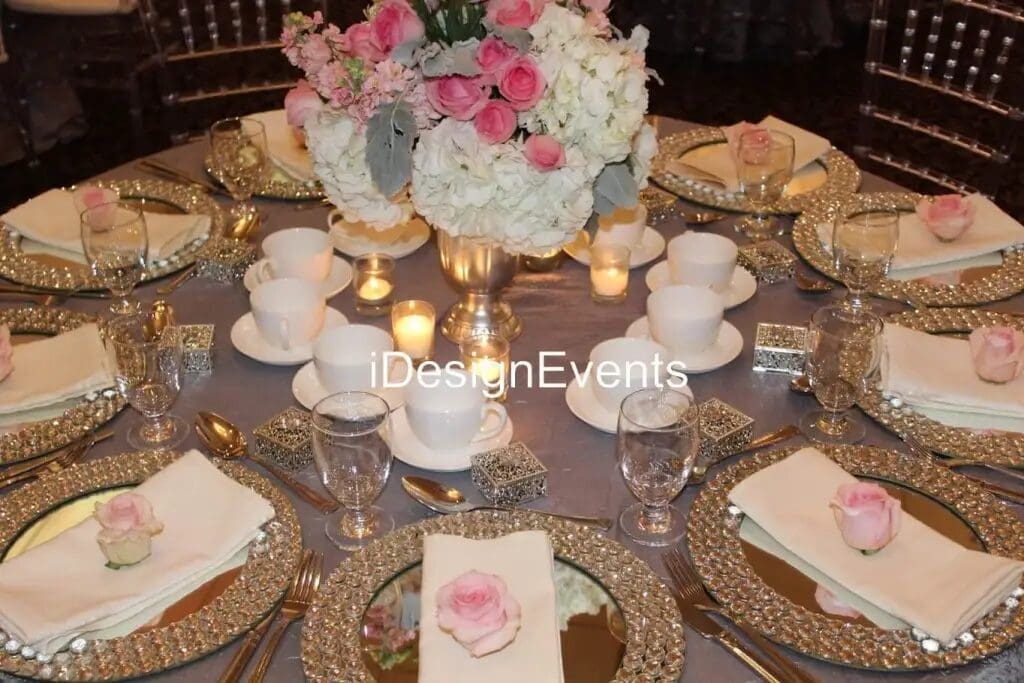 Elegant table setting with floral centerpiece and gold accents.