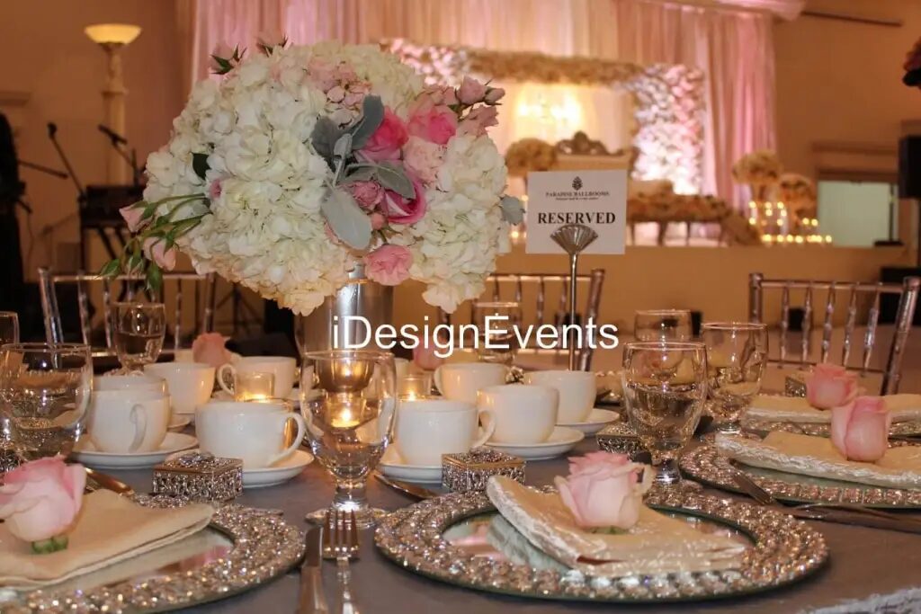 Futuristic roller coaster inside a vibrant, neon-lit indoor amusement park.