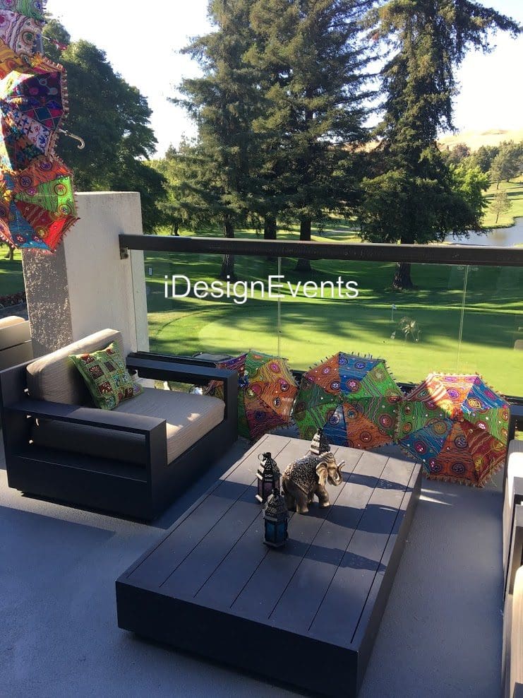 Cozy outdoor lounge with modern furniture and colorful cushions.