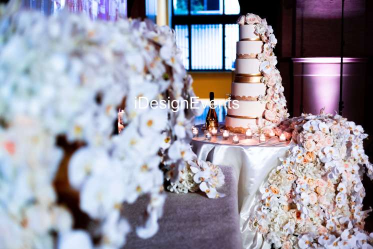 Elegant multi-tiered wedding cake with soft floral decorations.