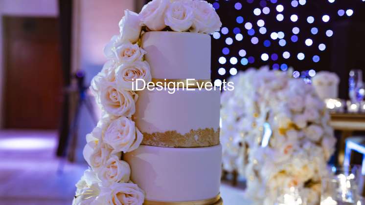 Elegant three-tier white wedding cake adorned with cascading roses.