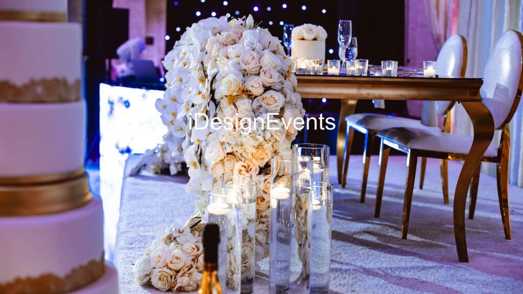 Elegant white floral centerpiece with candles at a formal event.