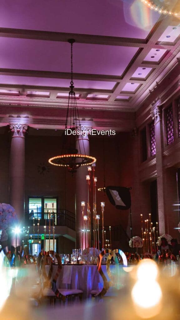 Elegant event space with chandeliers and columns.